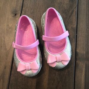 Pink and glittery baby crocs